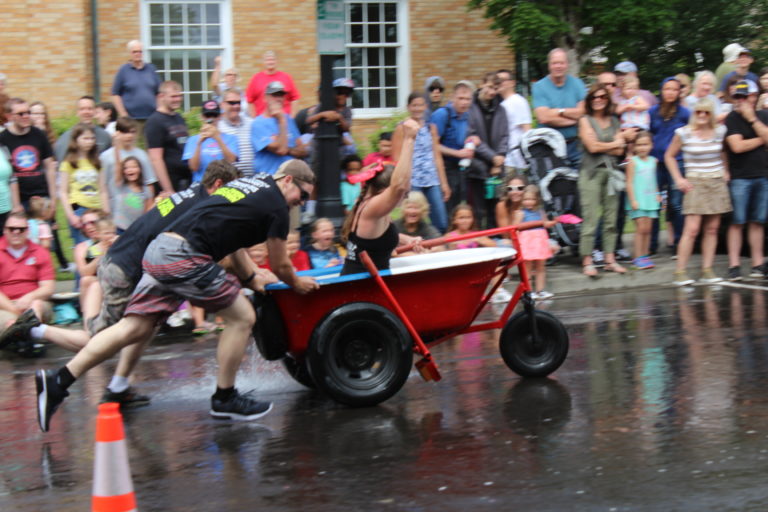 A member of the Chuck's Towing team, also known as the Bathtub Bandits, celebrates the team's victory at the Bathtub Races, held Saturday, July 27.