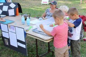Children participate in a sensory activity at the Someday School tent at the Pirates in the Park event at William Clark Park on Saturday, Aug. 4. Someday School is a new private school in Washougal that will begin classes Sept. 9. (Doug Flanagan/Post-Record)