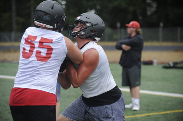 Camas High School lineman Caadyn Stephen (right) works on blocking techniques during the first practice of the season on Aug.