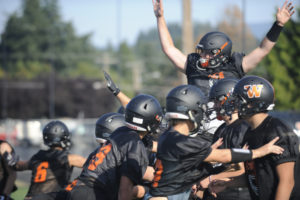 The Washougal High School football team practices blocking field goal attempts at Fishback Stadium on Wednesday, Aug. 28. Above: Senior Tommy Liston (right) practices a blocking scheme, making room for senior slot reciever Brevan Bea (center) at a recent practice session. (Photos by Wayne Havrelly/Post-Record)