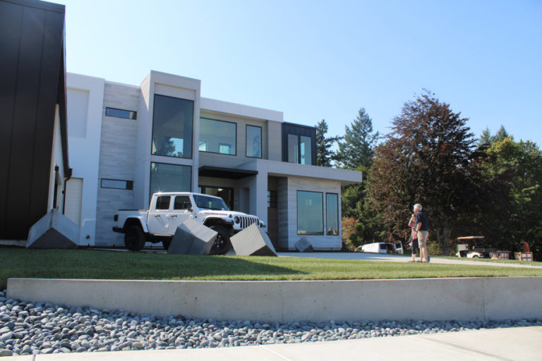 Visitors walk toward The Nakshatra home, by Axiom Luxury Homes, during the first day of the 2019 NW Natural Parade of Homes on Friday, Sept.