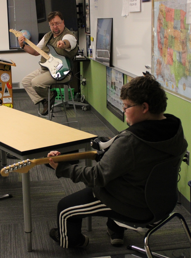 Jemtegaard Middle School teacher Scott Rainey instructs Tristan Simmons during a Club 8 guitar group session on Thursday, Sept.