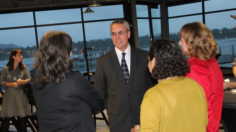 Charles Goeken (middle), one of four finalists for the city of Washougal&#039;s police chief position, talks with attendees at a reception Sept.