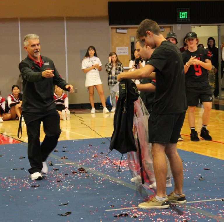 Doug Flanagan/Post-Record 
 Camas High School kicker Bryce Leighton is presented with a jersey to denote his selection to the 2020 Under Armour All-American Game during a school assembly on Friday, Oct. 4.