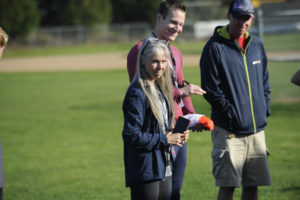 Camas High School cross country coach Laurie Porter (left) and assistant coaches Andrew Kaler (center) and Matt LaGrande talk strategy as the Papermakers' boys and girls teams prepare for postseason action. (Wayne Havrelly/Post-Record)