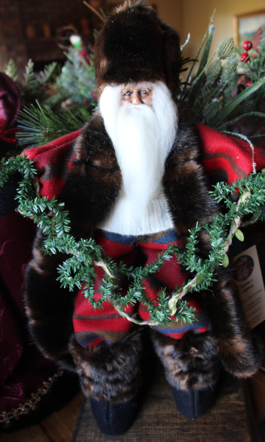 Kelly Moyer/Post-Record 
 Sandy Havrelly, a retired Hathaway Elementary School teacher, has been crafting these beloved &quot;Sandy&#039;s Santas&quot; to sell at the Washougal United Methodist Church Holiday Bazaar, a fundraiser for the church and local families in need, for at least 20 years. Each Santa is unique and has his own personality and accessories, like this garland-carrying Santa dressed in red Pendleton wool and fur. (Contributed photo courtesy of Sandy Havrelly)