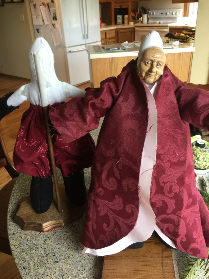 One of &quot;Sandy&#039;s Santas&quot; tries on his clothing during creator Sandy Havrelly&#039;s crafting process.