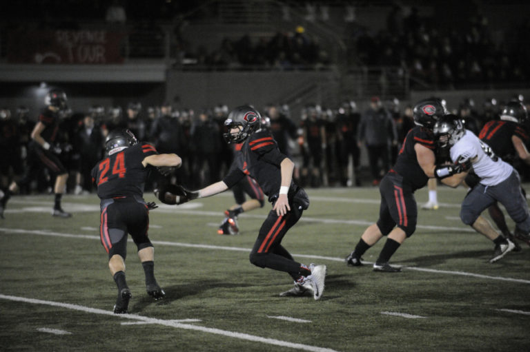 Camas High School senior quarterback Blake Ascuitto hands off to senior running back Randy Yaacoub during the Papermakers' 28-14 win over Union High School on Nov. 1.