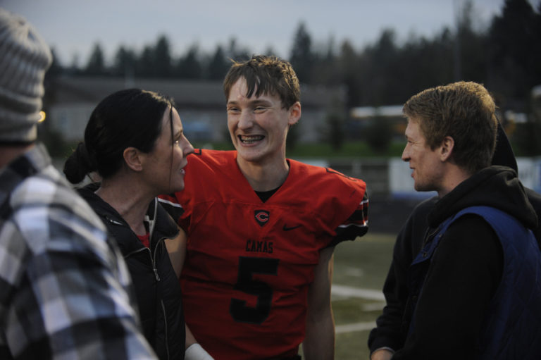 Camas High School senior quarterback Blake Ascuitto celebrates the Papermakers' 41-0 win over Eastmont High Shcool on Nov. 16 win with family and friends.