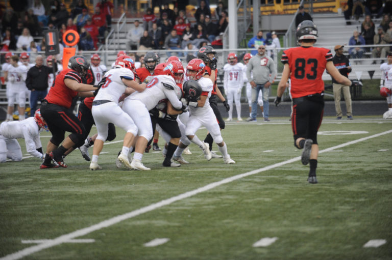 Camas High School junior running back Gabe Guo gets some help from his offensive line as they push together in a pile to pick up an additional 15 yards in the fourth quarter of the Papermakers' Nov. 16 game against Eastmont High School.