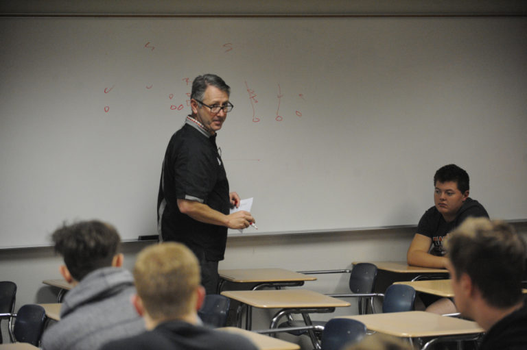 Washougal High School football coach Dave Hajek talks to his players in preperation for the Panthers&#039; 2A state tournament quarterfinal game against Lynden High School.