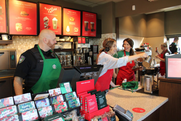 Camas Police Officer Gary Manning (left) waits for his next customer at the Nov.