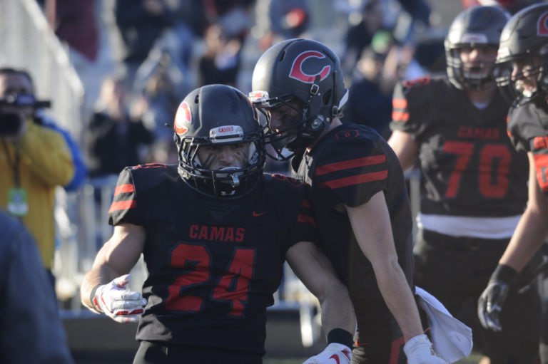 Camas senior Randy Yaacoub celebrates with teammates after a long touchdown run  against Puyallup at Doc Harris Stadium on Nov. 23.