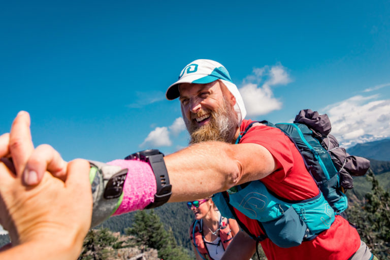 Ultramarathon runner Dave Stinchfield celebrates at the 185-mile mark during a 206.5-mile race around Mount St.