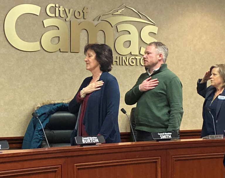 Newly elected Camas Mayor Barry McDonnell (center) and newly elected Camas City Councilwoman Shannon Roberts (right), a United States Navy veteran, join Camas City Councilwoman Melissa Smith (left) and other council members during the Pledge of Allegiance at the start of the city council's Dec.