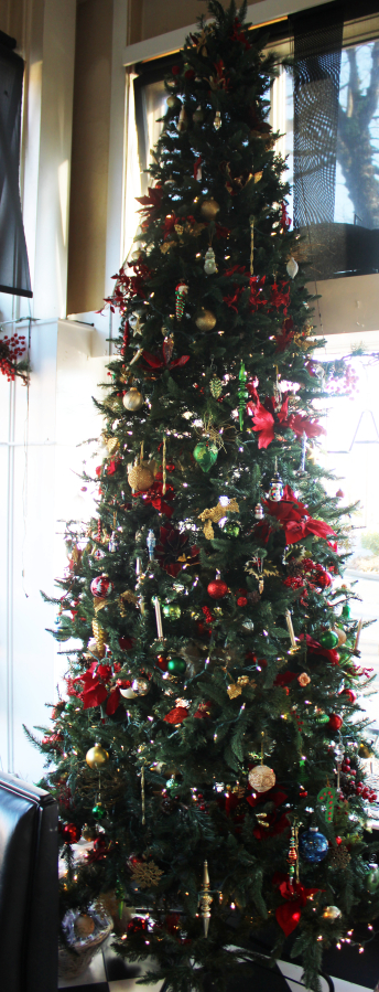 At left, a 16-foot Christmas tree and, at right, a &quot;Nutcracker&quot; doll are displayed in the front window of Natalia&#039;s Cafe in Camas.