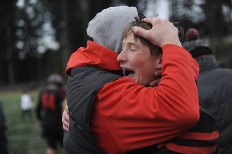 Camas High School senior quarterback Blake Ascuitto lets out some bottled-up emotion after the Papermakers beat Mount Si High School to advance to the 4A state championship game. At left: Camas senior Randy Yaacoub finds a hole during the 4A state tournament semifinal game at McKenzie Stadium on Nov. 30. Yaacoub rushed nine times for 53 yards against Mount Si.