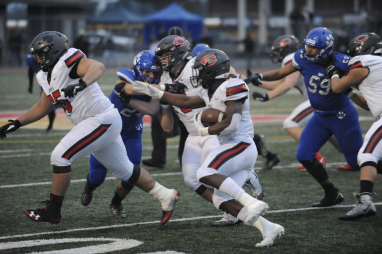 Camas High School&#039;s Jacques Badolato-Birdsell follows a block from senior offensive lineman Tristan Souza during the 4A state championship game on Dec. 7 in Tacoma.