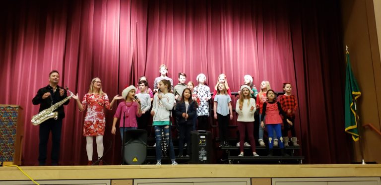 (Contributed photo courtesy of Camas School District)
Saxophonist and Billboard-charting music artist Patrick Lamb (left) performs with Camas music teacher Natalie Wilson (second from left)'s Grass Valley VOCAL JAZZ ensemble on Dec. 18.