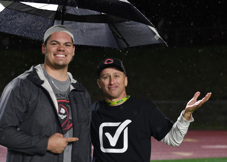 Kris Cavin shares a picture with Camas football player Caadyn Stephen at the 4A state championship game in Tacoma on Dec. 7.