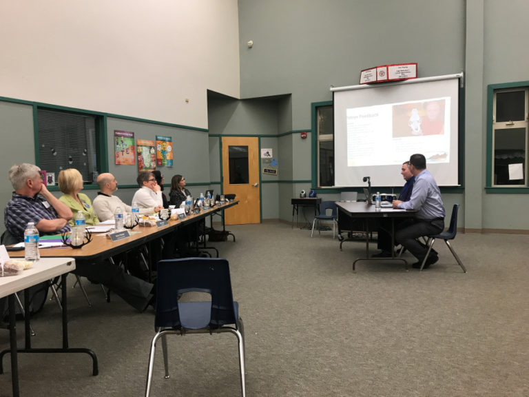 Assistant superintendent Aaron Hansen and director of technology and communications Les Brown (right) talk during a presentation at a Jan. 28 Washougal School District board of directors meeting at Cape Horn-Skye Elementary School. Hansen and Brown led a committee that recommended against changing the district&#039;s start times.