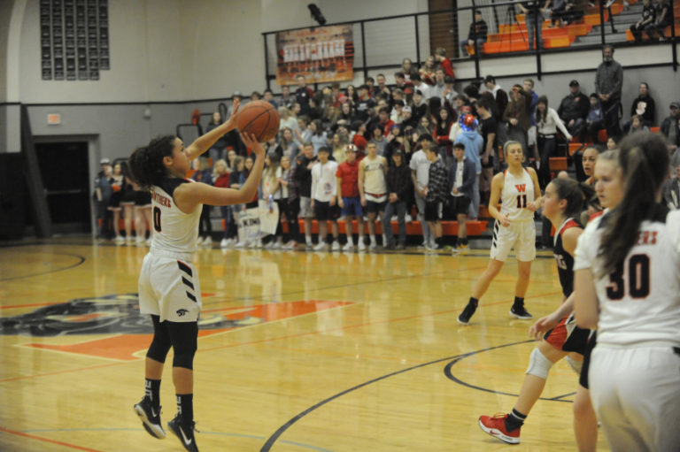 Washougal freshman point guard Chloe Johnson takes a 3-point shot in front of an excited home crowd against R.A. Long on Feb.