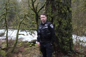 Doug Flanagan/Post-Record 
 Washougal Police Department officer Francis Reagan stands near the the area of the Washougal River where he helped to save a 28-year-old Portland resident who had fallen off her inner tube last May. Reagan was named as the 2019 Officer of the Year by the Washington Council of Police & Sheriffs last week. (Doug Flanagan/Post-Record)