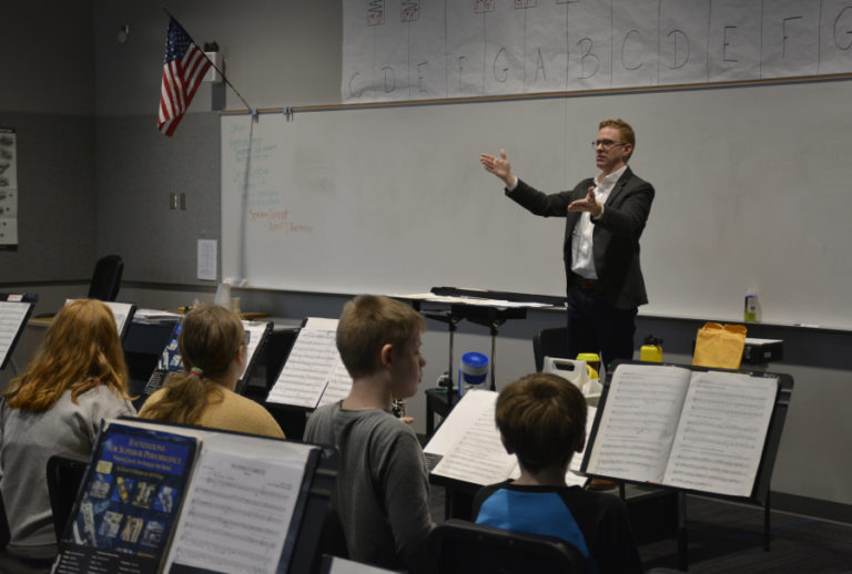 David Wacyk, assistant professor of music and director of bands at Saint Martin's University, speaks to Jemtegaard Middle School music students on Feb.