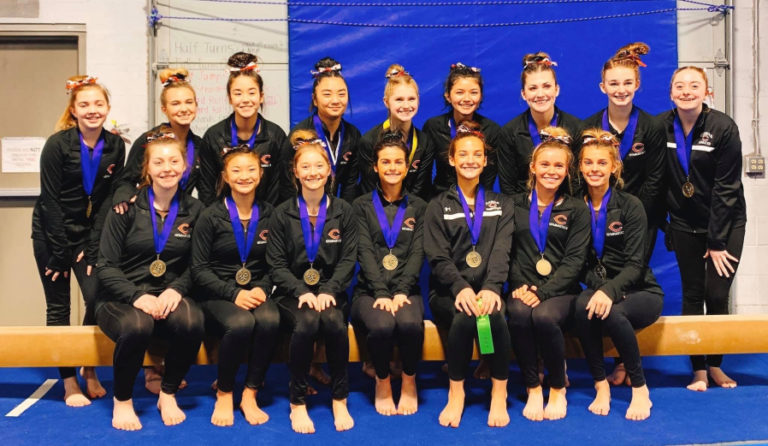 Members of the Camas gymnastics team pose for a photo after finishing an undefeated season with a victory at the 4A District 4 meet on Feb. 15 in Vancouver.