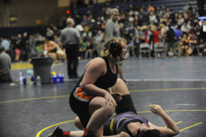 Washougal senior Vanessa Brooks gives a smile to her coaches after a come-from-behind pin in her first match at the Region 3 girls wrestling tournament in Kelso on Feb. 15.  Brooks qualified for Mat Classic in her first year of wrestling. (Wayne Havrelly/Post-Record)