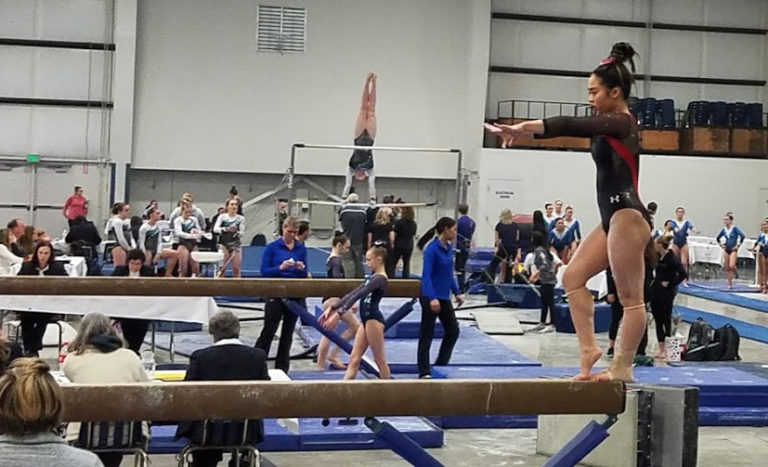 (Contributed photo courtesy of Kaylee Sugimoto) Kaylee Sugimoto performs a routine on a balance beam during the Oregon Optional State Meet in 2019.