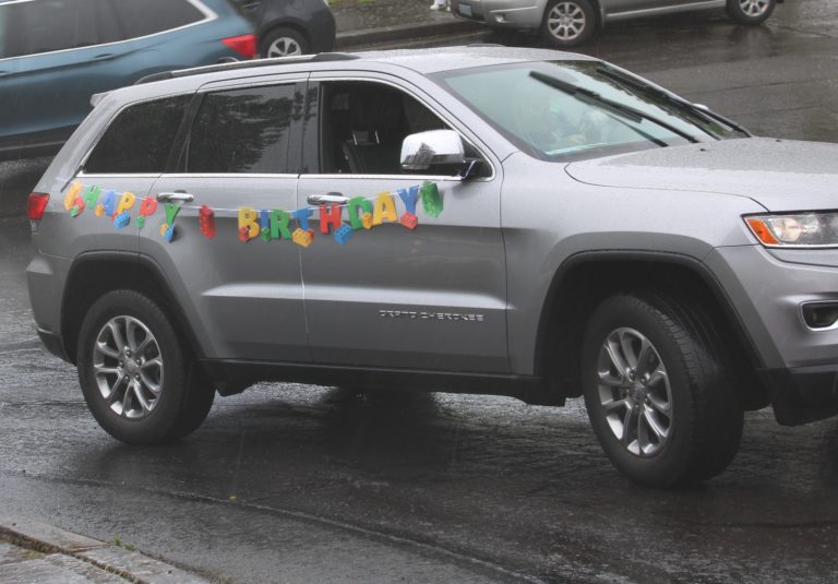 Former Camas City Councilwoman Deanna Rusch leads a volunteer "drive-by parade" past the home of Timothy Hergenroether on Sunday, May 3. Timothy, who is new to Camas, turned 8 on Sunday.