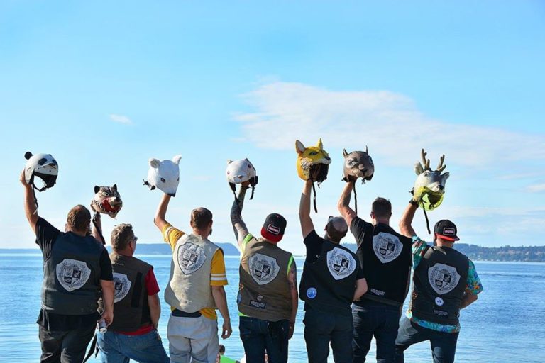(Contributed photos courtesy of Joe Hammill) The "Slow Ride Home" riders, including Camas native Joe Hammill (far right) and his fellow Soldiers of Destiny Scooter Club members Ron Araya, Justin Barnes, Paul Green, Sean Porter, Elliott Snyder and Derric Tanner wave their "spirit animal" helmets at the end of their 11-day ride -- on scooters -- from Florida back to Seattle, Wash.