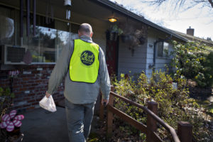 Luepke Center manager Dean Scelza drops off a food delivery for Meals on Wheels People on March 16. The agency has seen a 32 percent increase in local delivery requests during the COVID-19 crisis. (Photo courtesy of The Columbian)