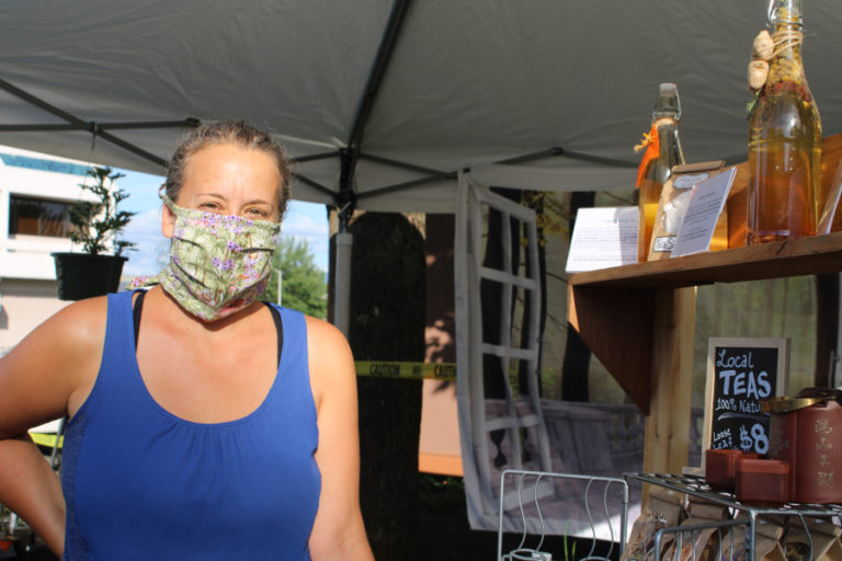 Christina Safford, of The Lady in the Window, a Camas-based business that sells plant starts and herbal teas, shows her selection of teas for sale at the June 10 Camas Farmer's Market.