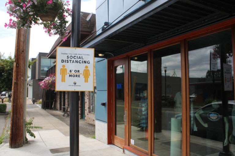A sign, seen June 29 in downtown Washougal, reminds people to maintain proper social distancing during the pandemic.