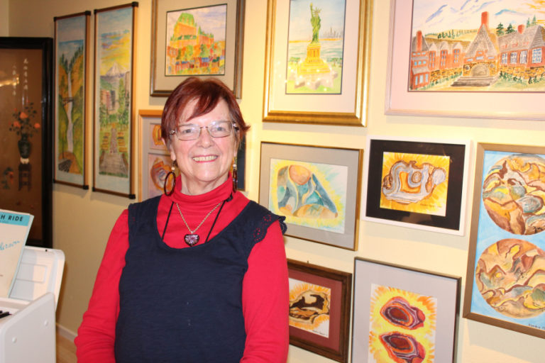 Sandra Smith Gangle stands inside her Camas home in 2018, near some of the artwork she's created to remember the many places she and her husband, Gene (not pictured), have visited over the years. In her recently published memoir, "Madam Arbitrator," Gangle reflects on going to law school in the 1970s as a married mother of two children and on her role as Oregon's first female labor arbitrator.