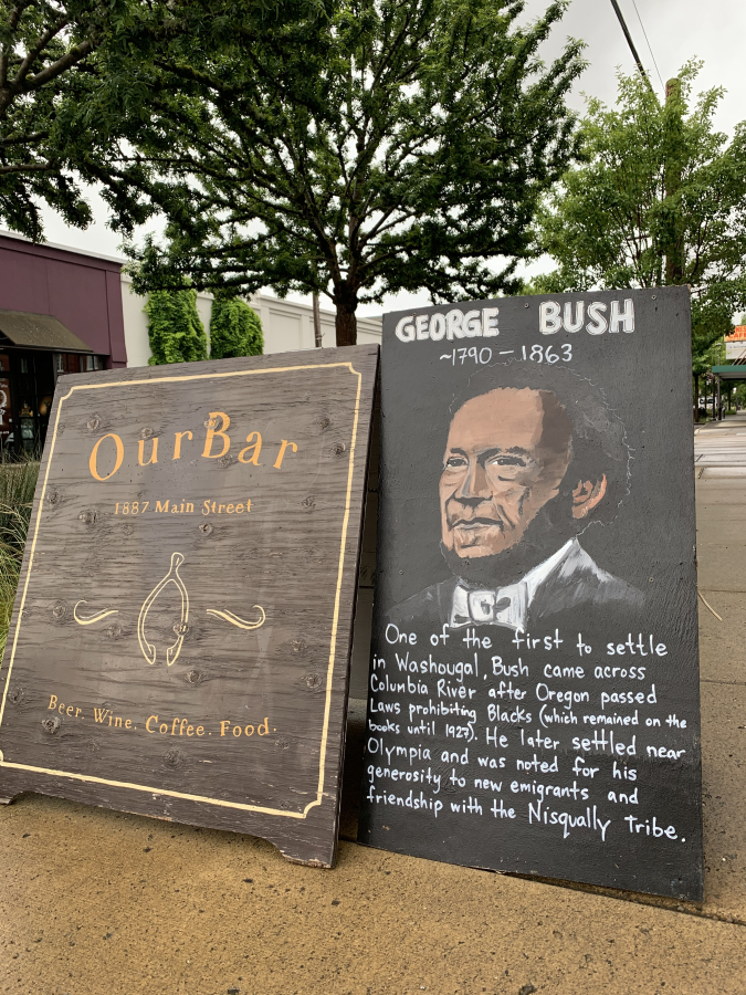 A sandwich board outside OurBar restaurant in downtown Washougal describes the contributions of early Washougal settler George Bush.