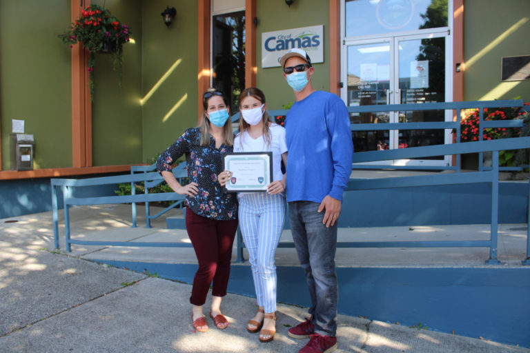 Maddison "Maddy" Gregory (center) stands with her parents, Desirae Gregory (left) and Dustin Gregory (right) in front of Camas City Hall on Aug. 7. Maddy Gregory was one of three Vancouver teens honored by Camas officials last week for their heroic rescue of a father and his 5-year-old daughter at the Camas Potholes swimming area in July.