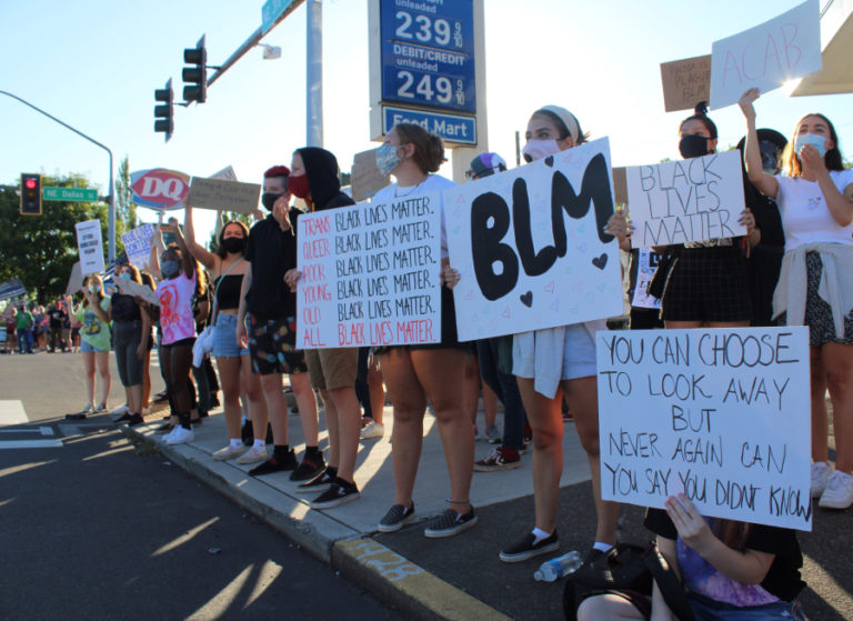 Young people gather, holding signs in support of the Black Lives Matter movement, during a counterprotest to a "Back the Blue" pro-police rally happening in downtown Camas on Friday, Aug.