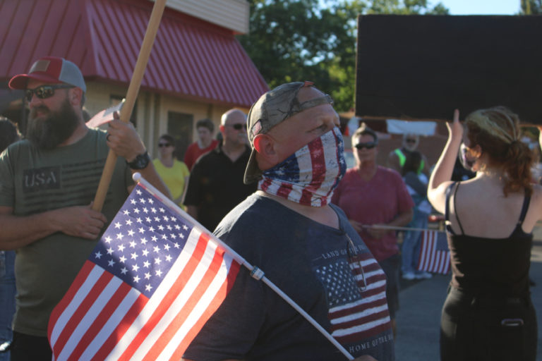 A man holds an American flag at a pro-police "Back the Blue" rally in downtown Camas on Friday, Aug. 28.