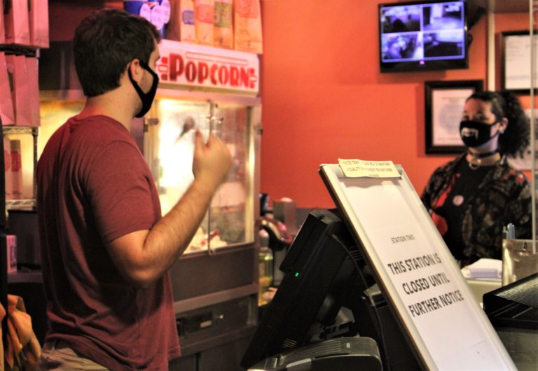 Liberty Theatre employees Jakob Potter (left) and Avery Zehner (right) prepare for the historic downtown Camas theater's first show in seven months on Friday, Oct. 9.