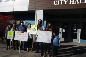 Washougal residents gather in front of City Hall on Oct. 27, 2020, to protest higher-than-normal water bills. The residents have asked city leaders to explain the reasons behind the increased bills, which they say were unexpected and excessive. (Doug Flanagan/Post-Record)
