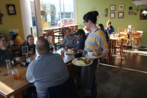 OurBar manager Sara Wakeman serves meals to a group of people at the Washougal restaurant on Nov. 22, 2019. OurBar permanently closed on Oct. 31, 2020. (Doug Flanagan/Post-Record)
