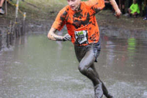 Post-Record file photos 
 Washougal's Gabriel Dinnel powers through the mud during a 2018 cross country meet in Idaho. The 2020 fall high school sports season in Washington was postponed due to the ongoing COVID-19 pandemic. Some low-risk, local high school sports, including cross country, are set to begin practice Feb. 1, 2021. (Post-Record file photo)