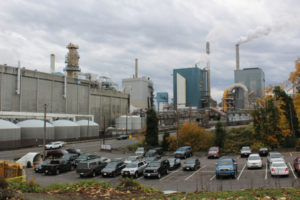 Cars fill a parking lot across from the Georgia-Pacific paper mill in downtown Camas in 2018. (Post-Record file photo)