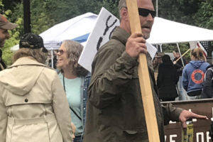 A man holds a sign during a rally held Tuesday, May 25, 2021, at the Washougal School District's administration office. (Doug Flanagan/Post-Record)