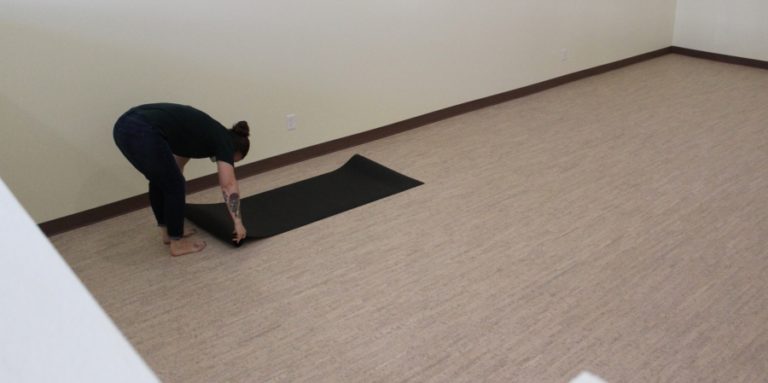 Yoga studio owner Pam Rollins rolls out a mat at her Forest Moon Yoga studio in downtown Washougal on Thursday, July 22, 2021.