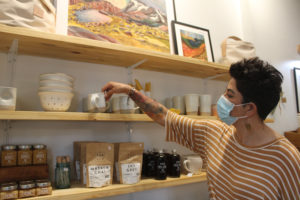 Lori Cano, owner of the new Poppy & Hawk retail shop in downtown Camas, straightens a stoneware coffee mug crafted by Hanselmann Pottery, a studio out of Corrales, N.M., on Thursday, Aug. 26, 2021. (Photos by Kelly Moyer/Post-Record)