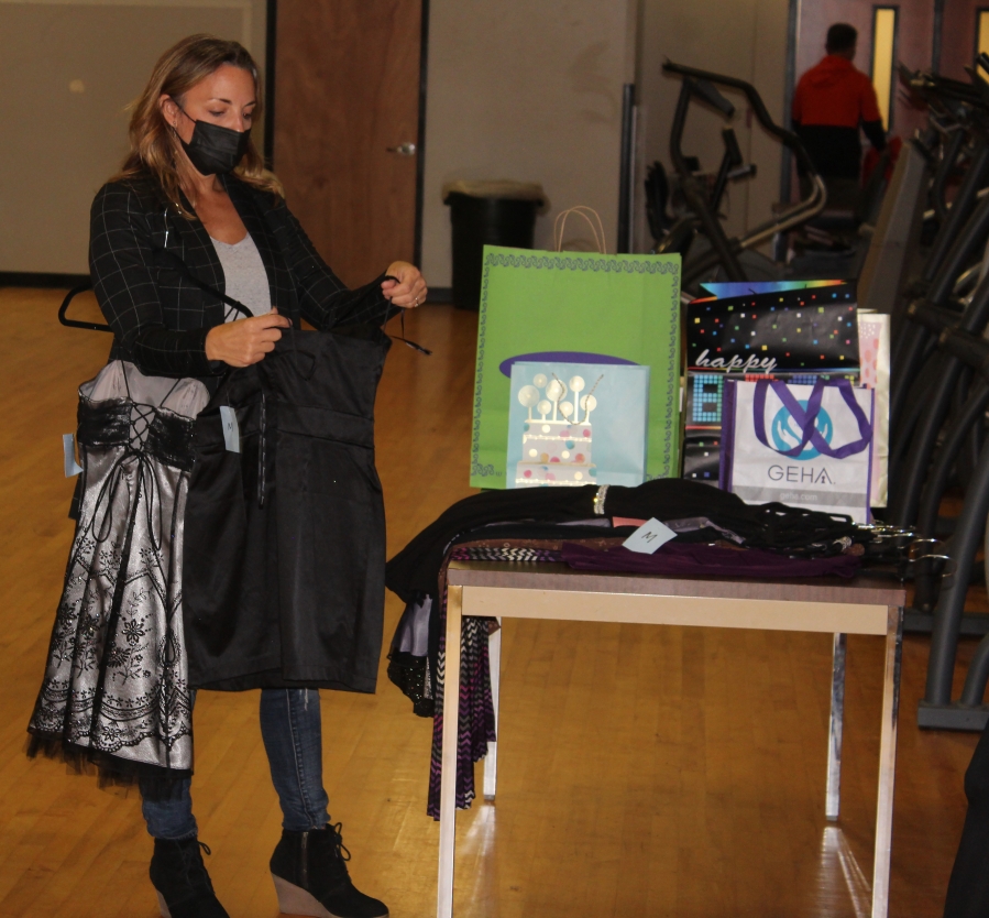 Doug Flanagan/Post-Record 
 Tara Poulsen organizes dresses during the "Giving Gown Gala" event at Washougal High School on Oct. 8.